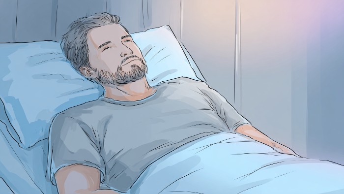 Patient en récupération après une arthrodèse lombaire, illustrant la douleur postopératoire et la convalescence.